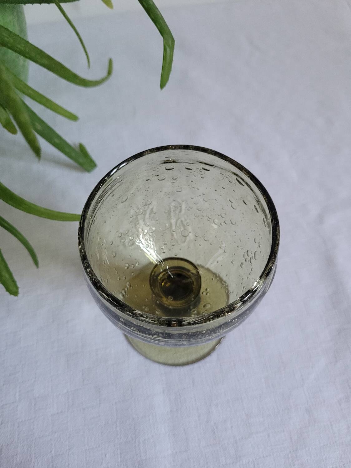 Footed glass made of blown glass