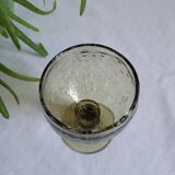 Footed glass made of blown glass