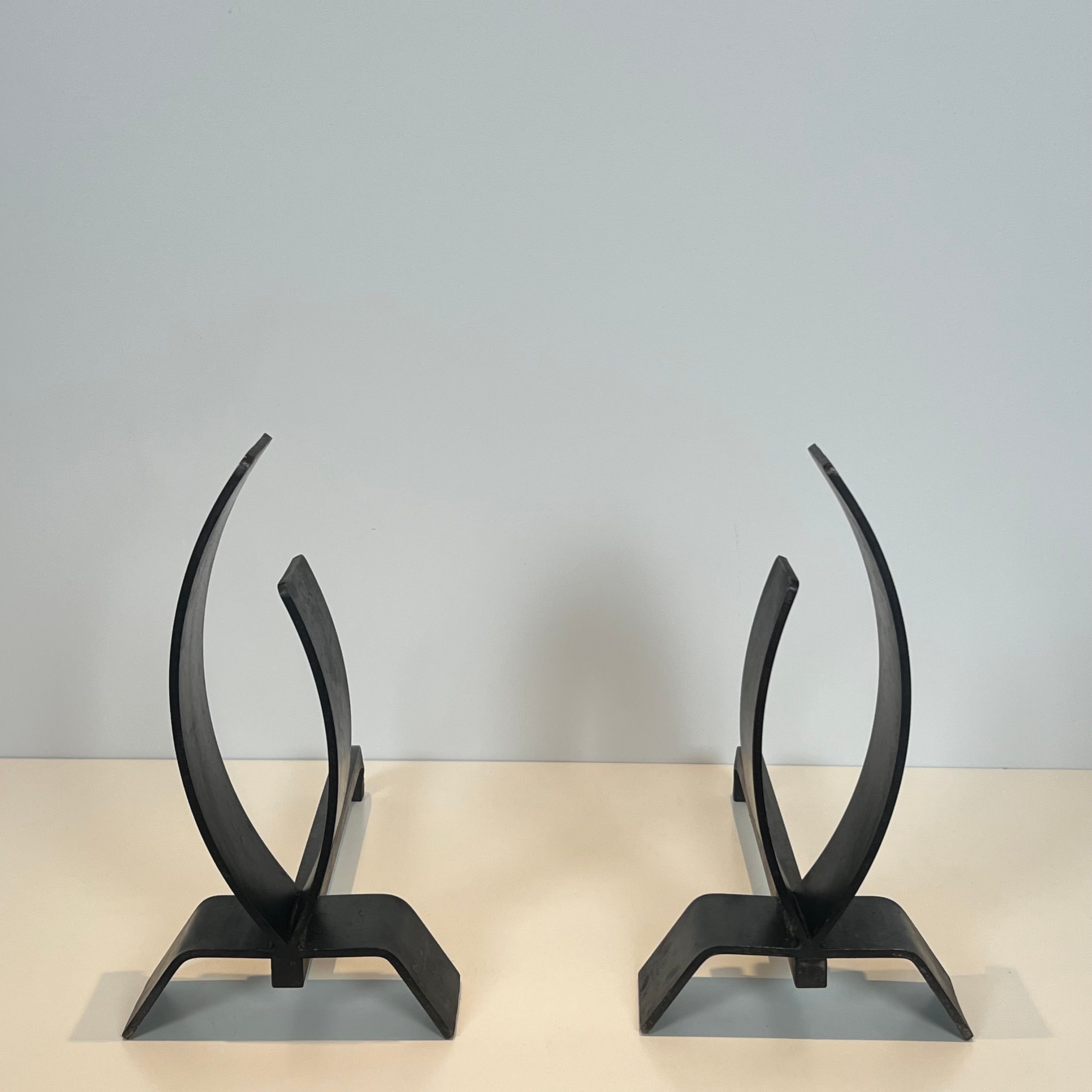 Pair of modernist andirons in steel and wrought iron