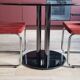 Round black smoked glass dining table + 2 terracotta chairs