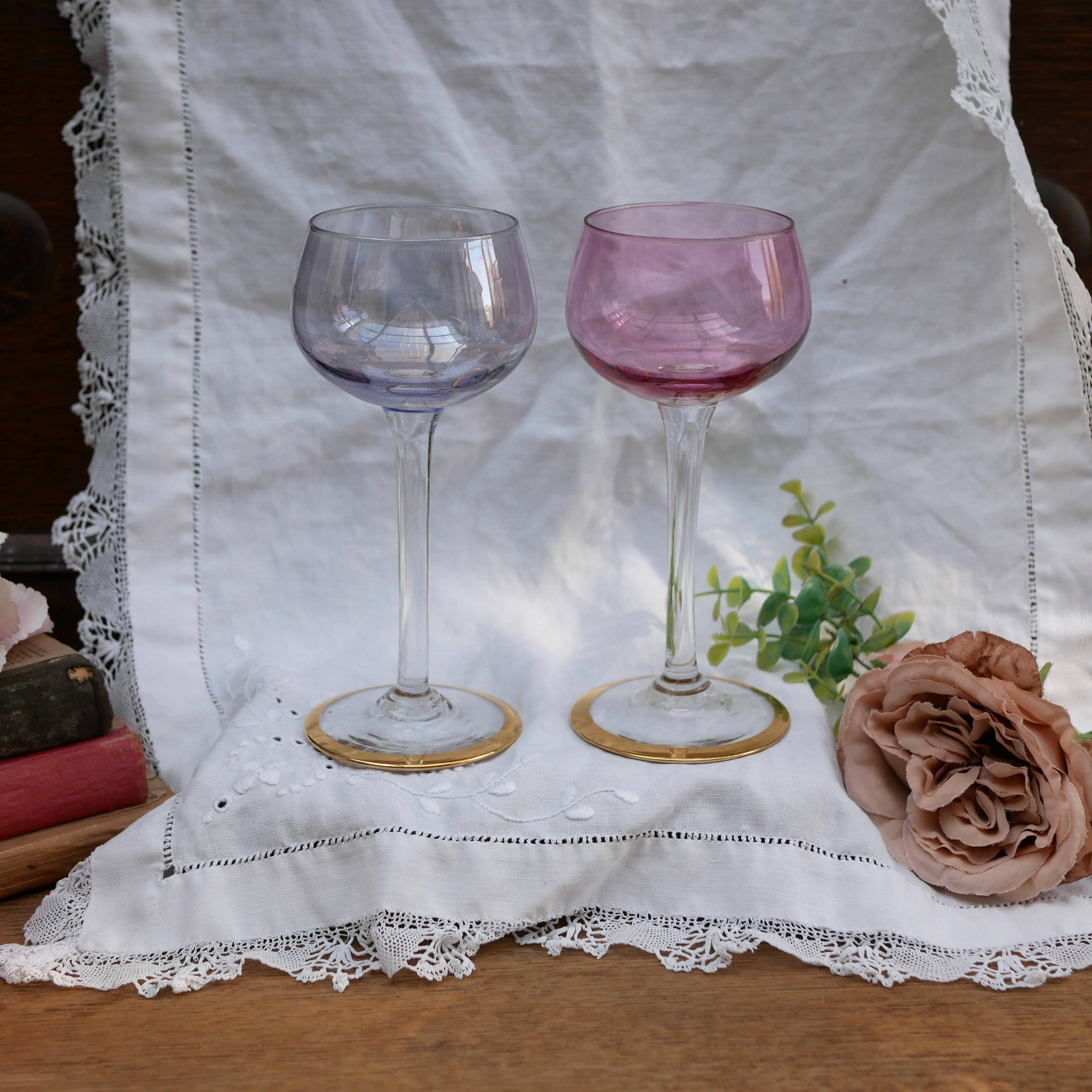 Four colorful stemmed wine glasses