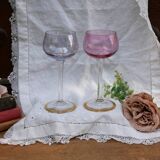 Four colorful stemmed wine glasses