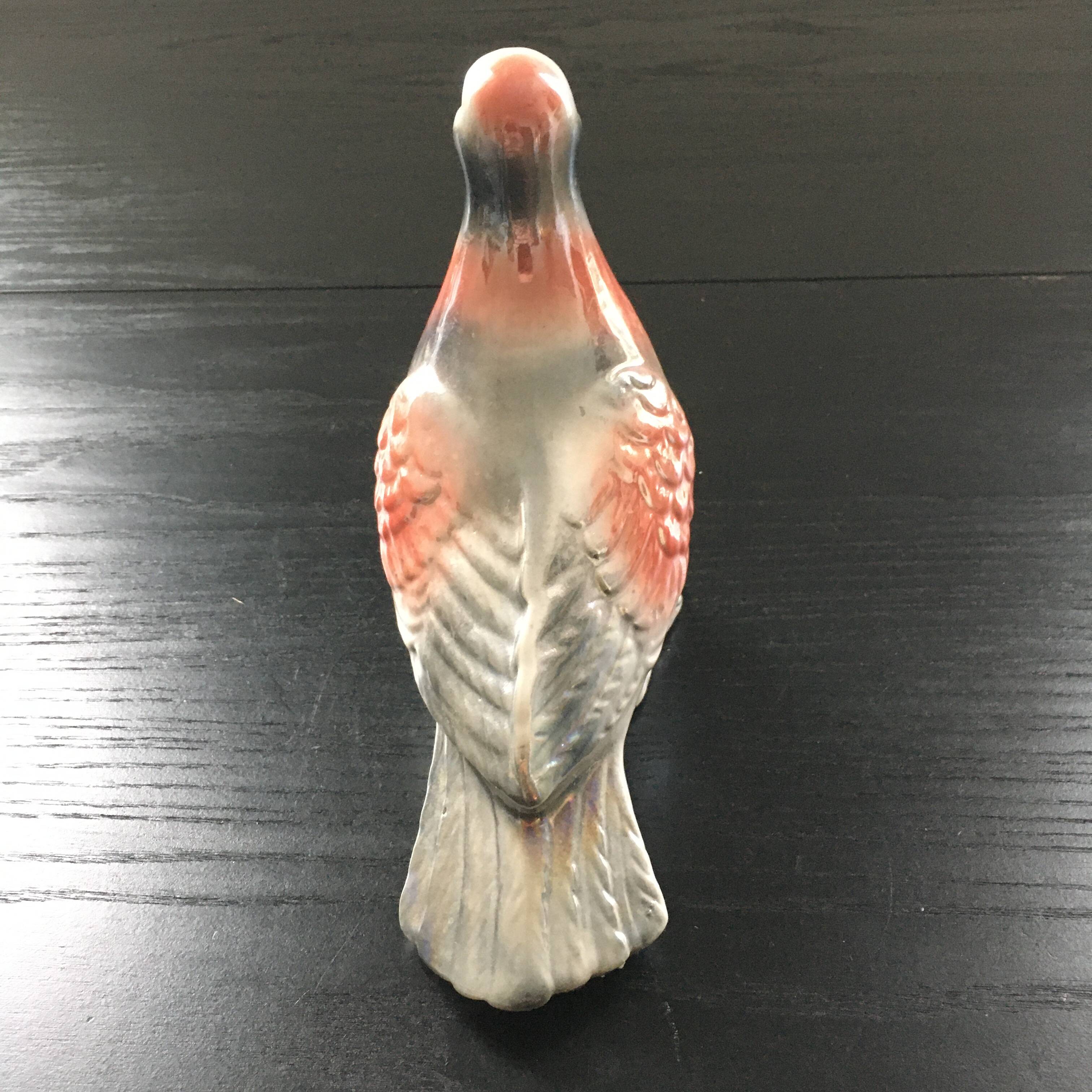 Antique bird in pearly ceramic