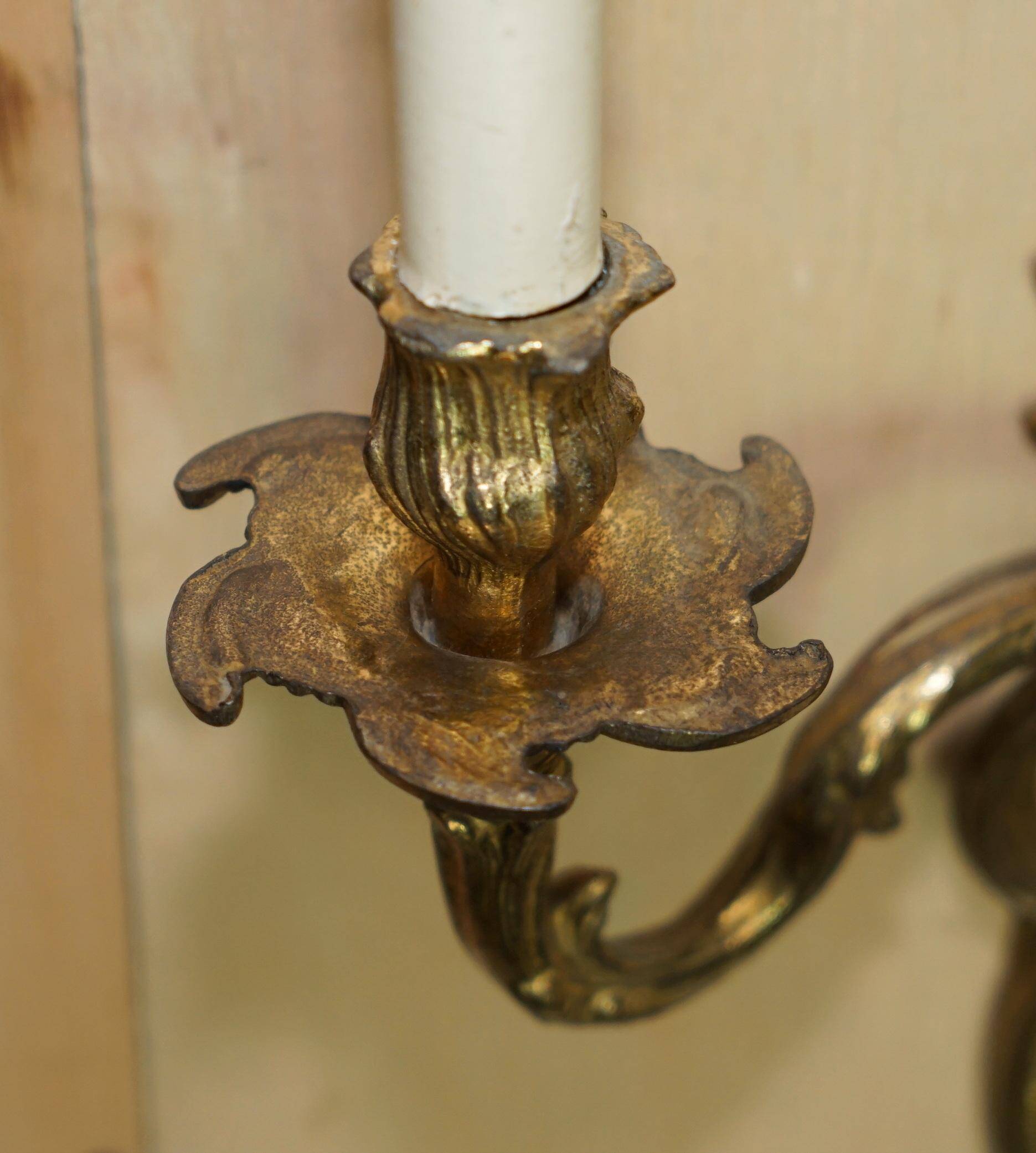 Pair of antique wall sconces from the 1920s in gilded bronze.