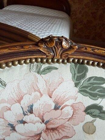 Louis XV style armchair upholstered in floral fabric.