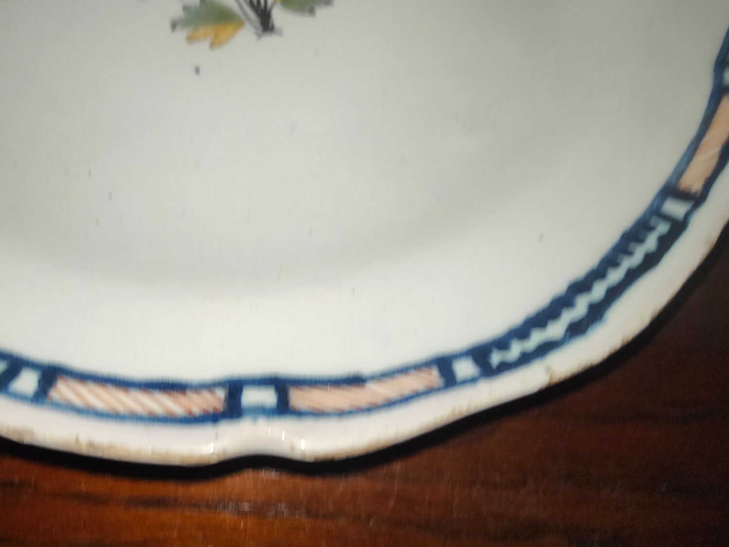 Old earthenware plate of the North XVIIIth Century with floral decoration