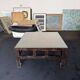 Vintage brutalist coffee table with Asian decor.
