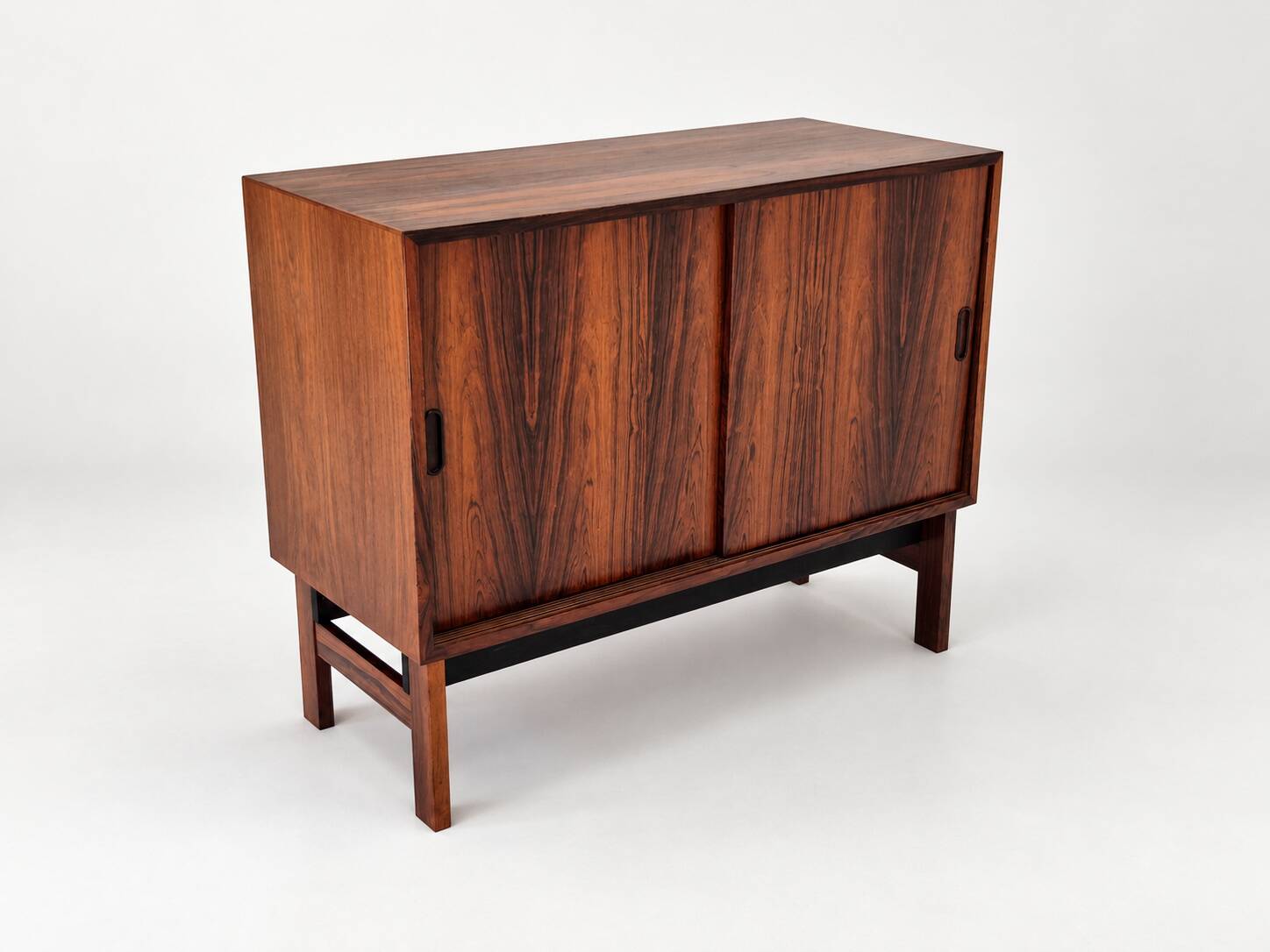 Low sideboard in rosewood with sliding doors. Denmark, 1960s