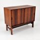 Low sideboard in rosewood with sliding doors. Denmark, 1960s