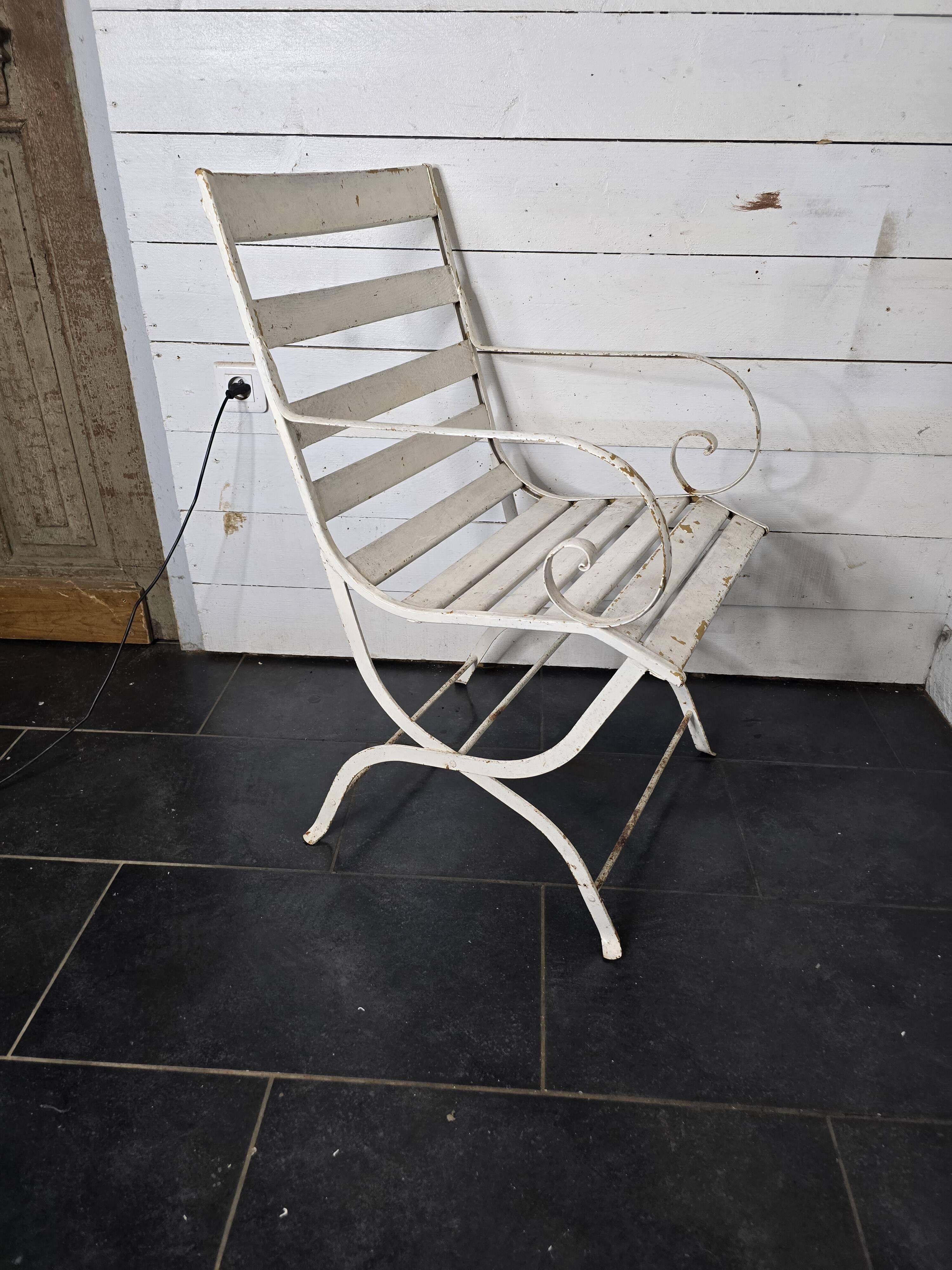 Old wrought iron and wood garden armchair