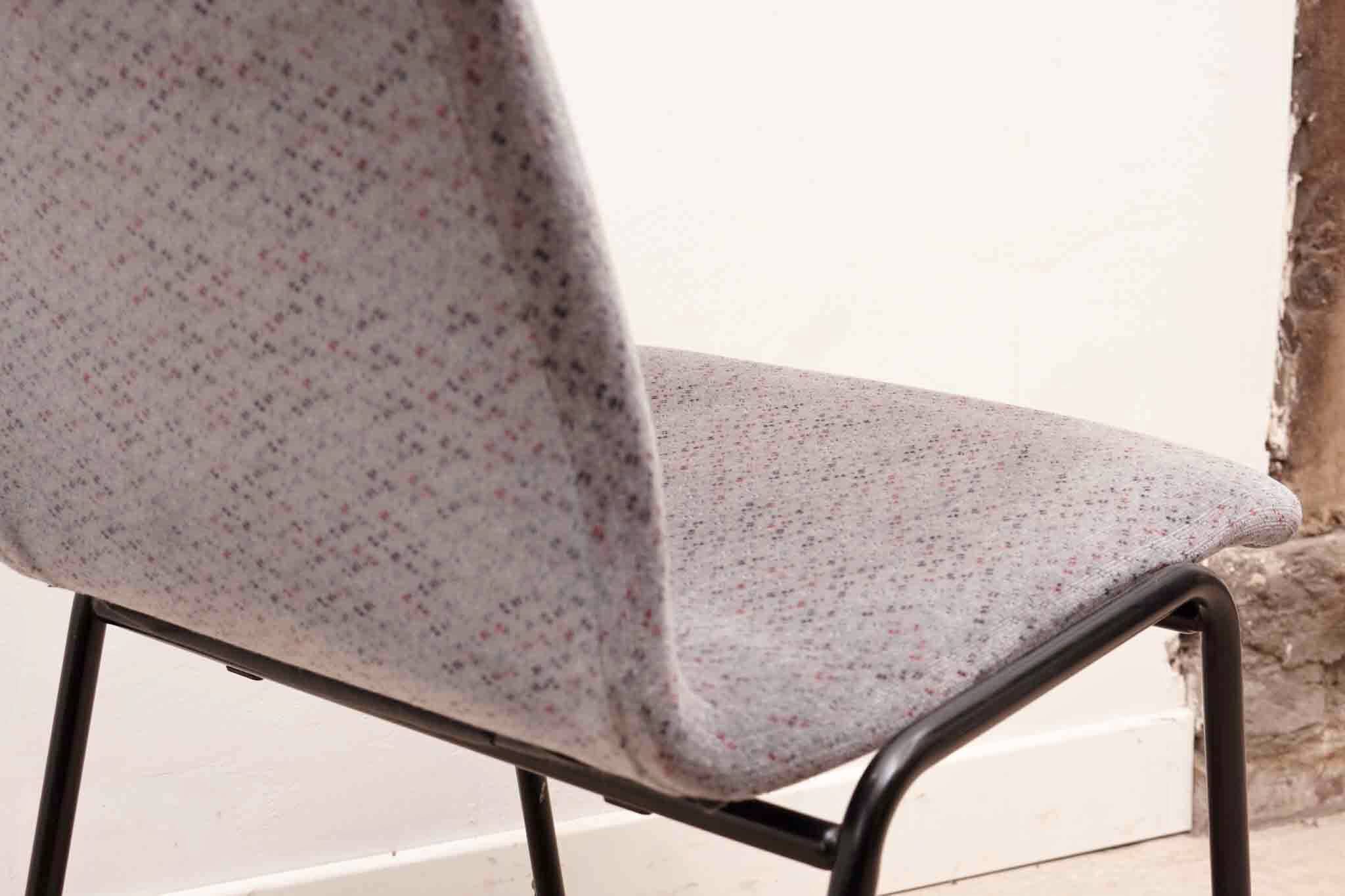 Grey fabric chair with pattern and black legs