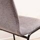 Grey fabric chair with pattern and black legs