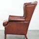 Cognac-coloured cow leather wingback armchair in English style