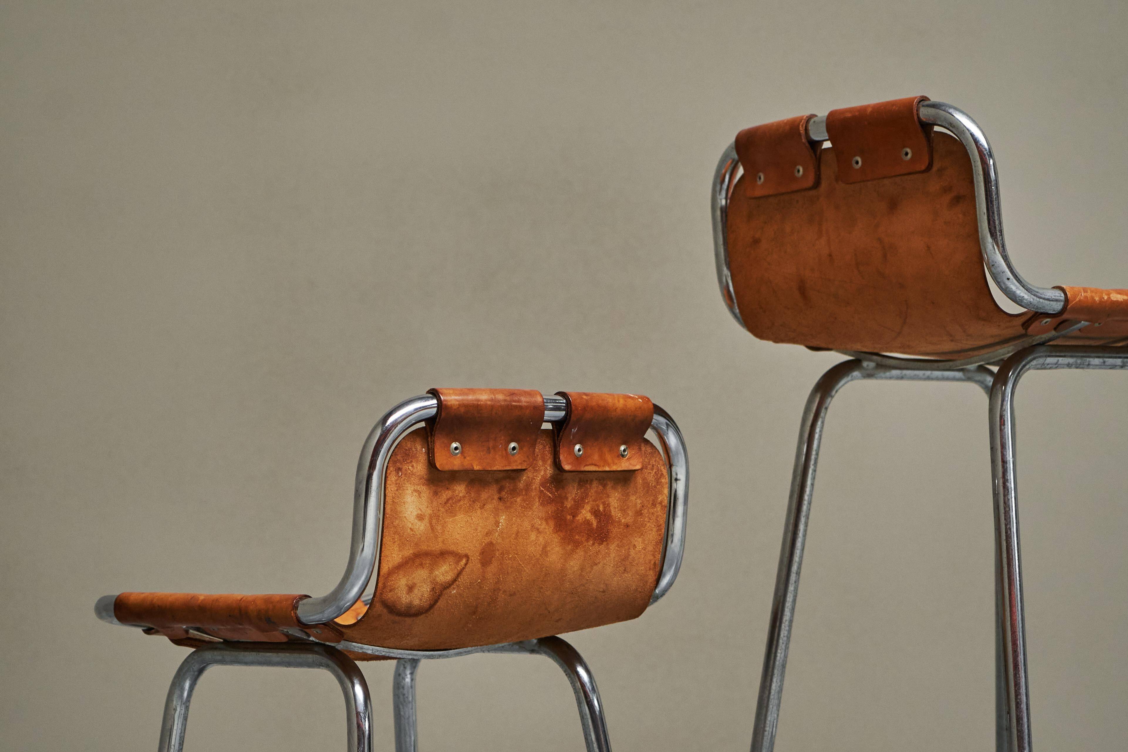 Set of 2 stools "Les Arcs" selected by Charlotte Perriand in leather.
