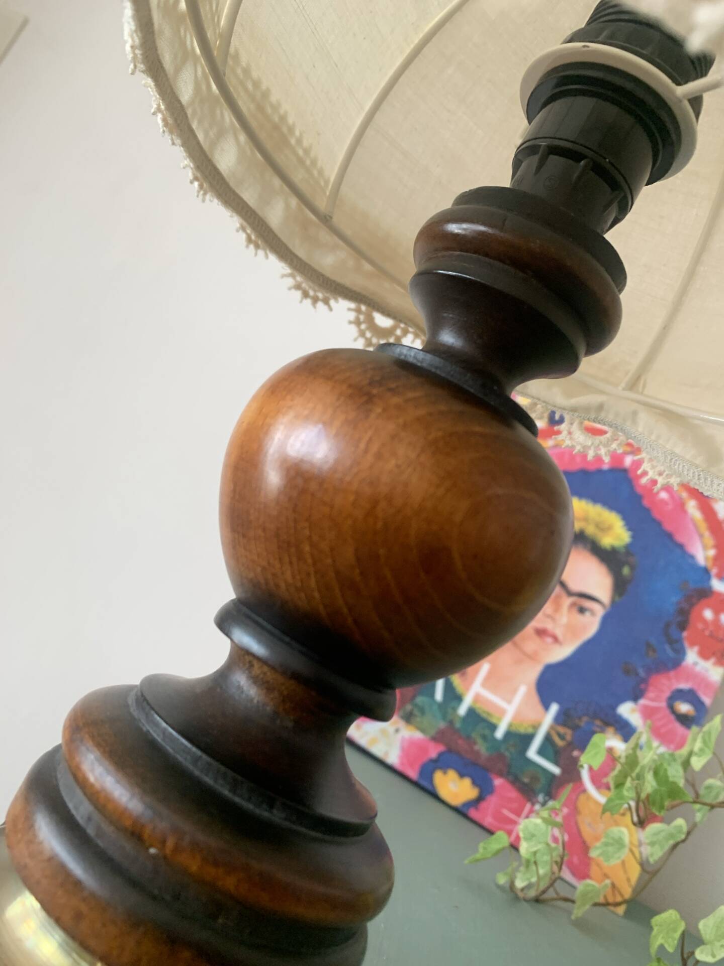 Small vintage wooden turned table lamp with a pleated shade.