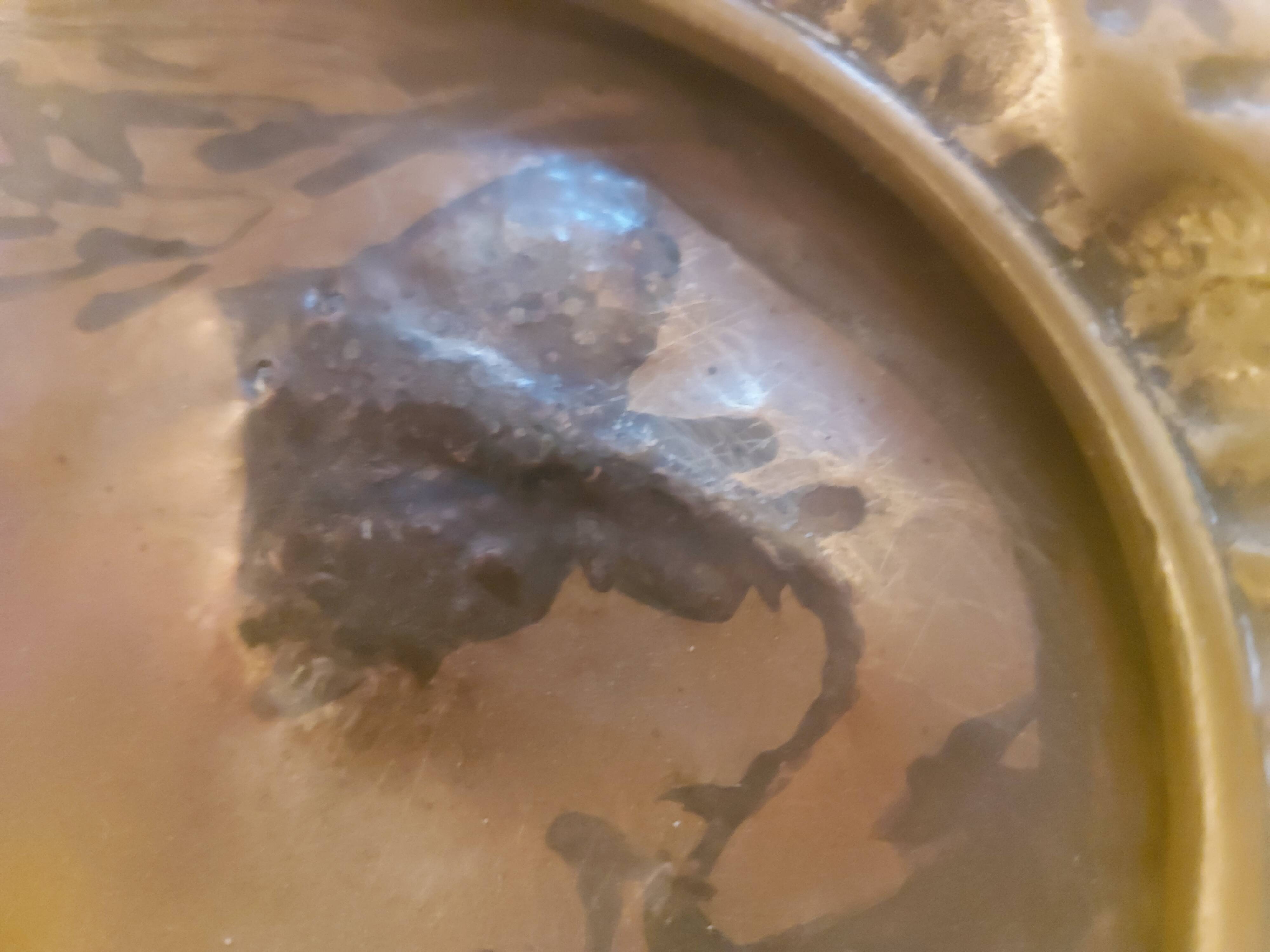 Decorative copper repoussé plate with marine motifs