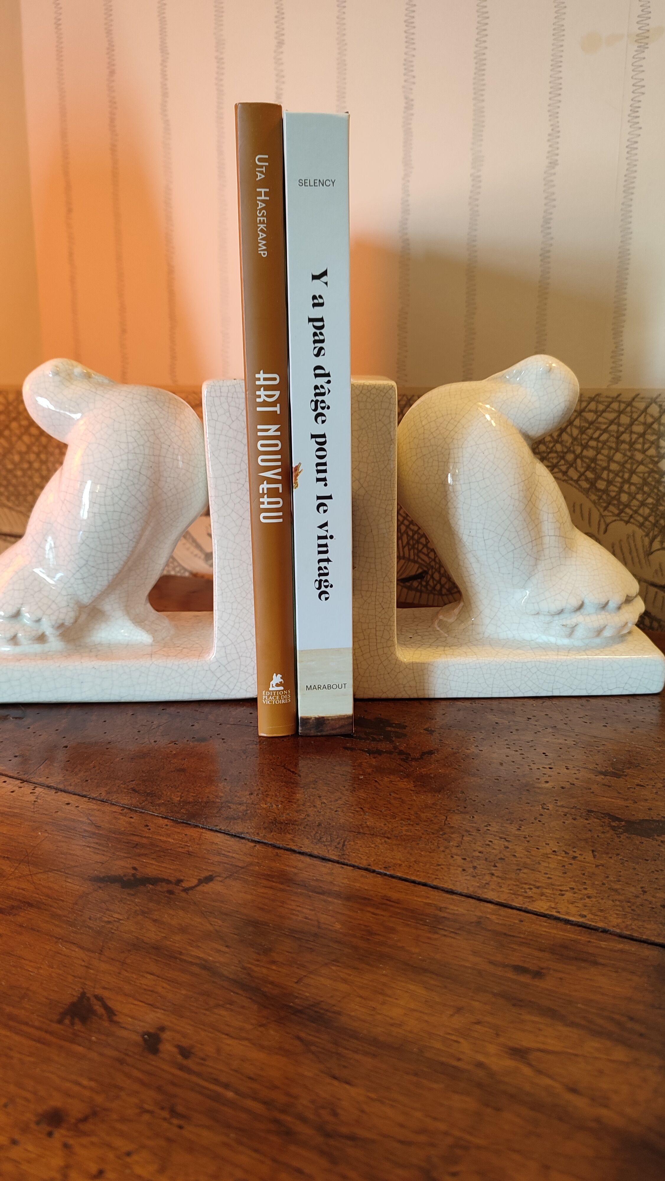 Pair of greenhouse art-deco books about cracked earthenware bird