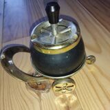 Original vintage ashtray on a small wheeled stand.