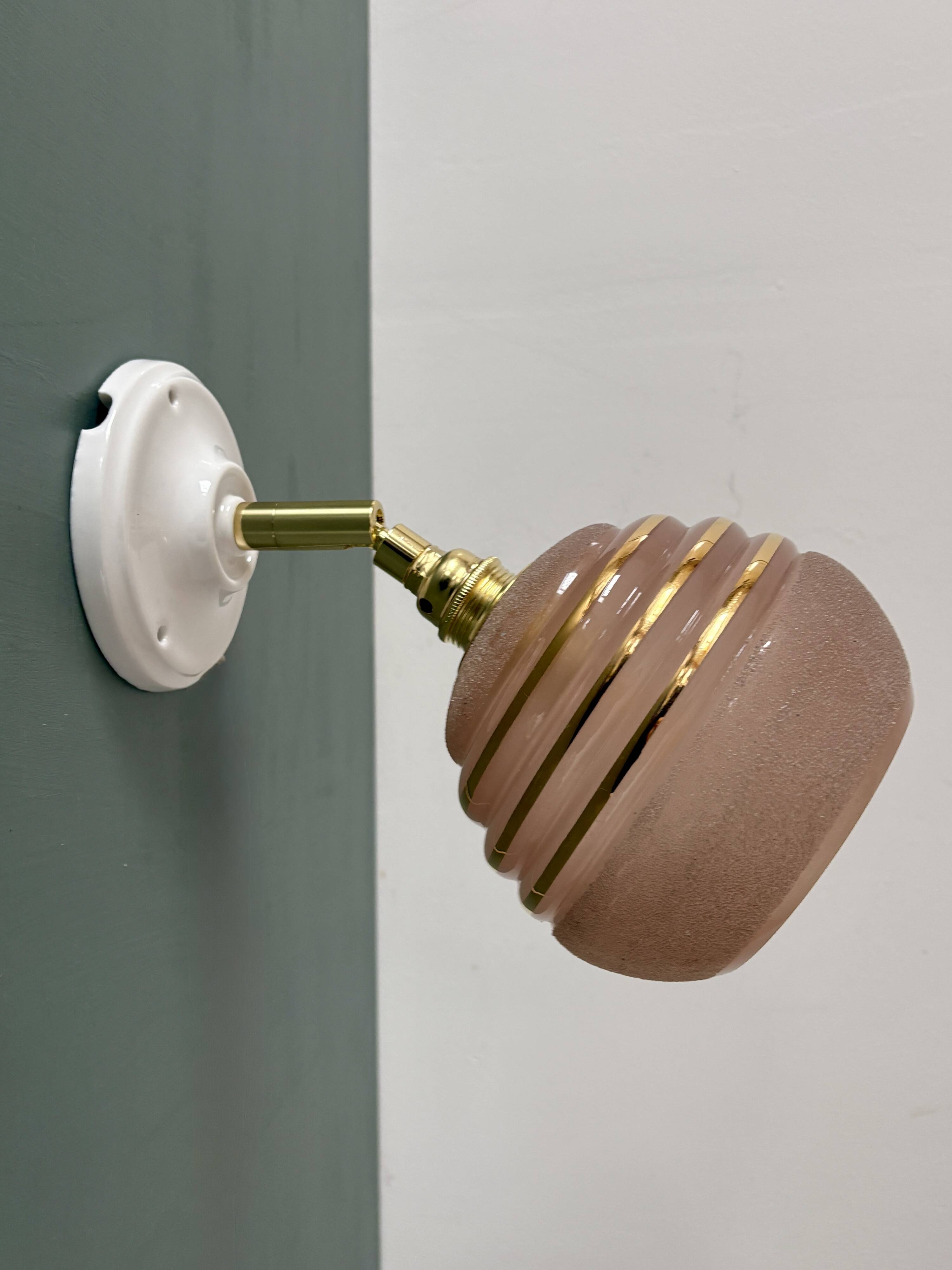 Vintage globe wall light in frosted pink and gold glass.