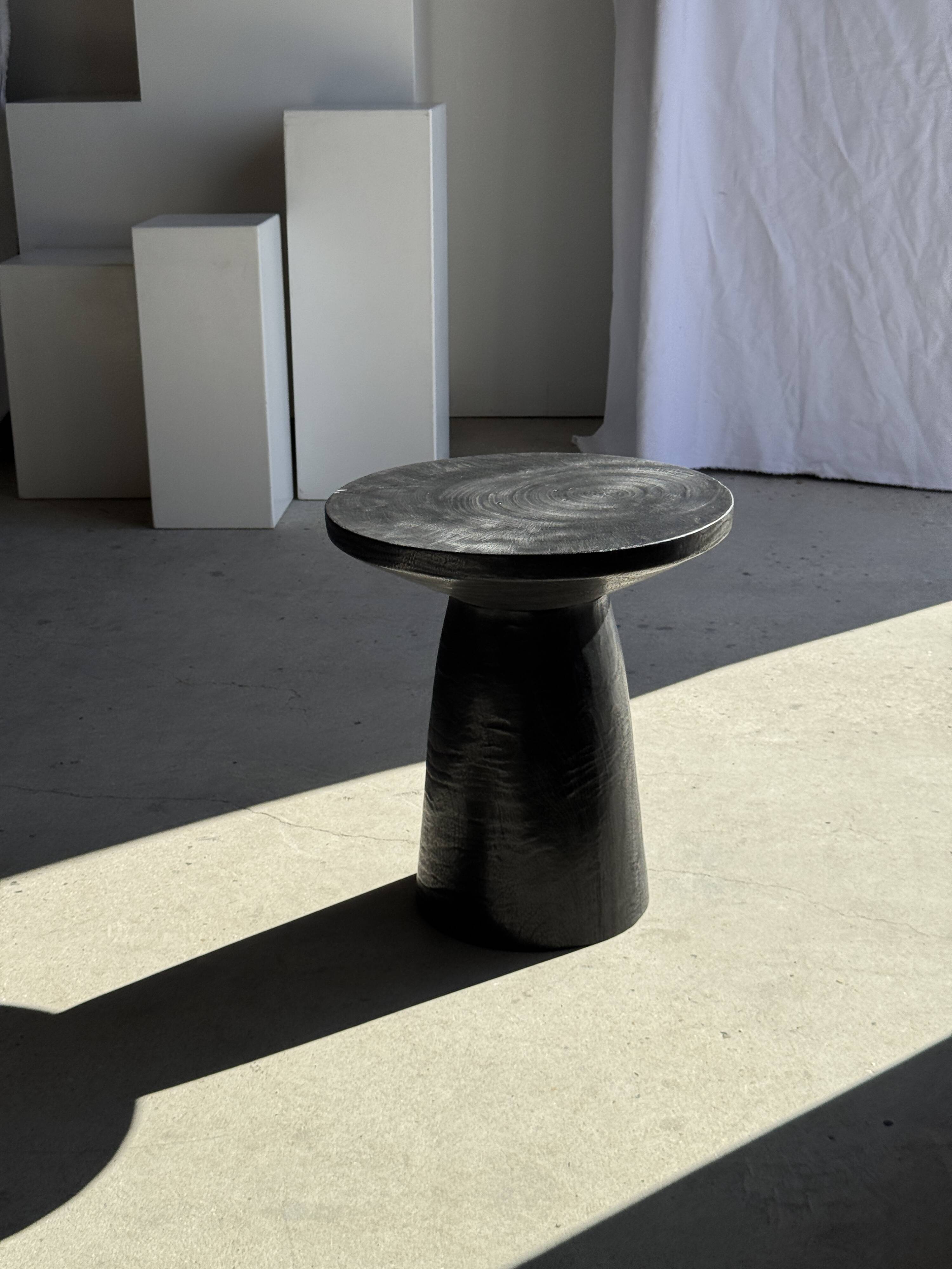 Black solid mango side table (monoxyle) with conical legs