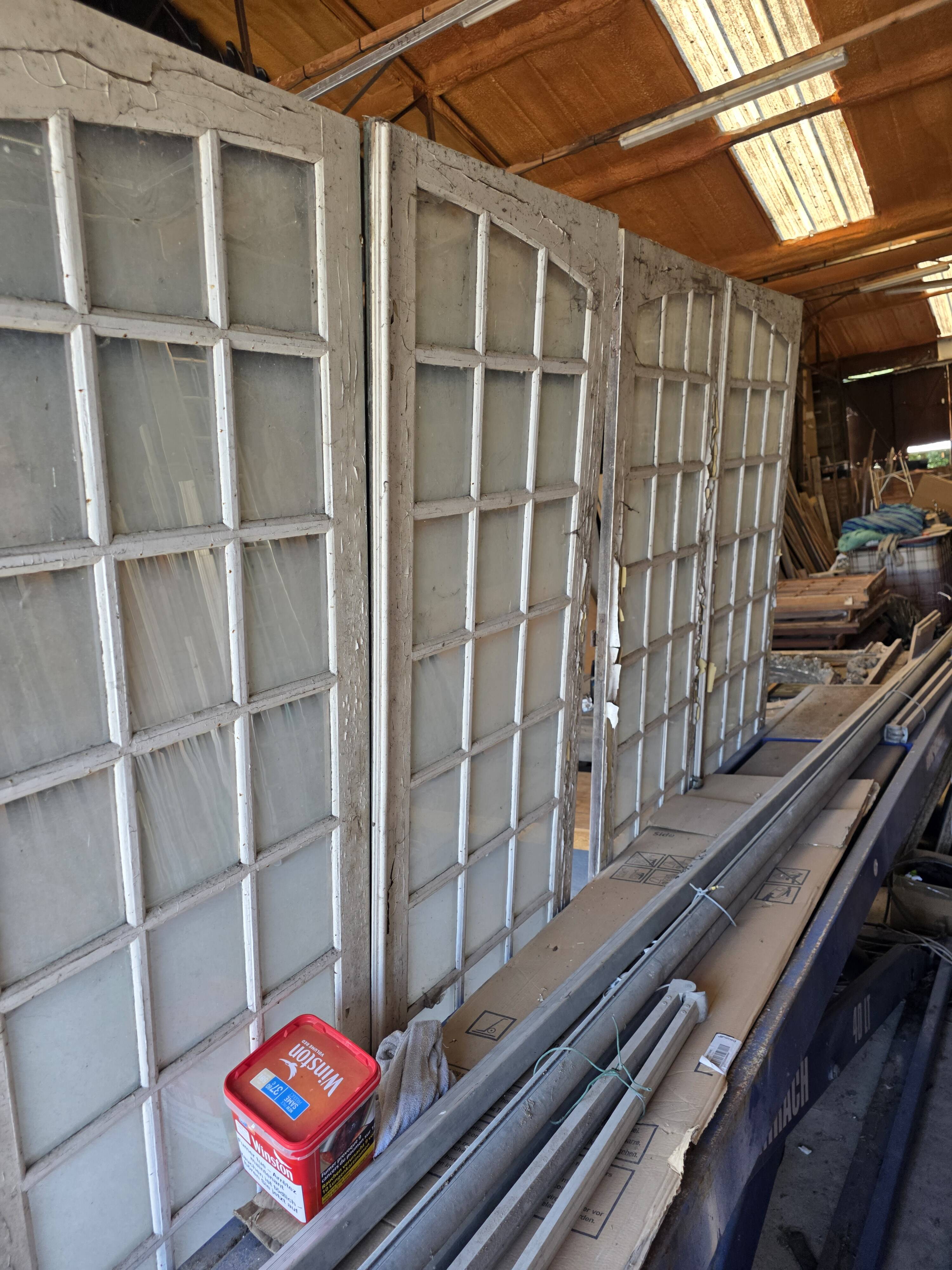 Two pairs of solid oak doors with small panes.