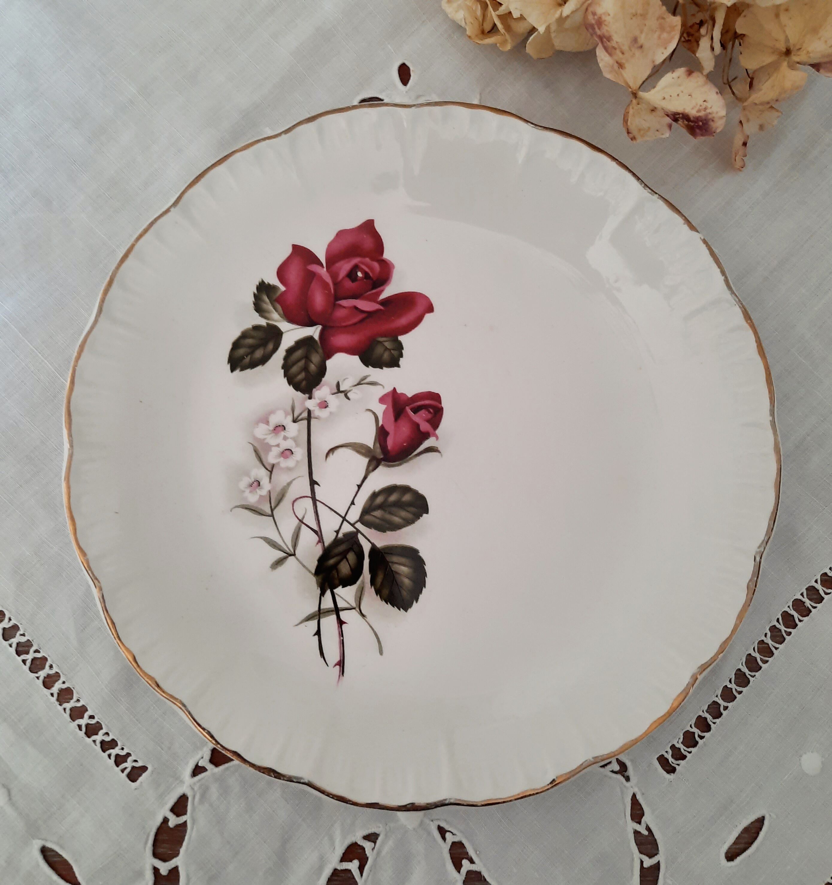7 mismatched antique dessert plates accompanied by a pie dish
