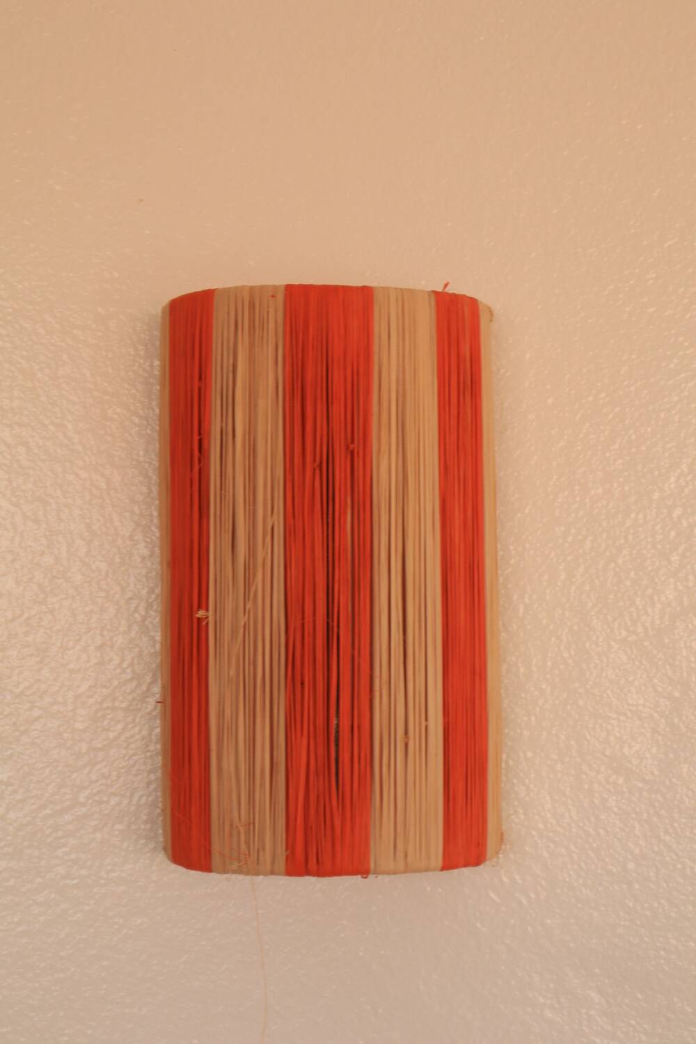 Orange and natural striped raffia wall light