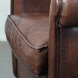 Great luxurious brown cowhide club armchair with matching piping
