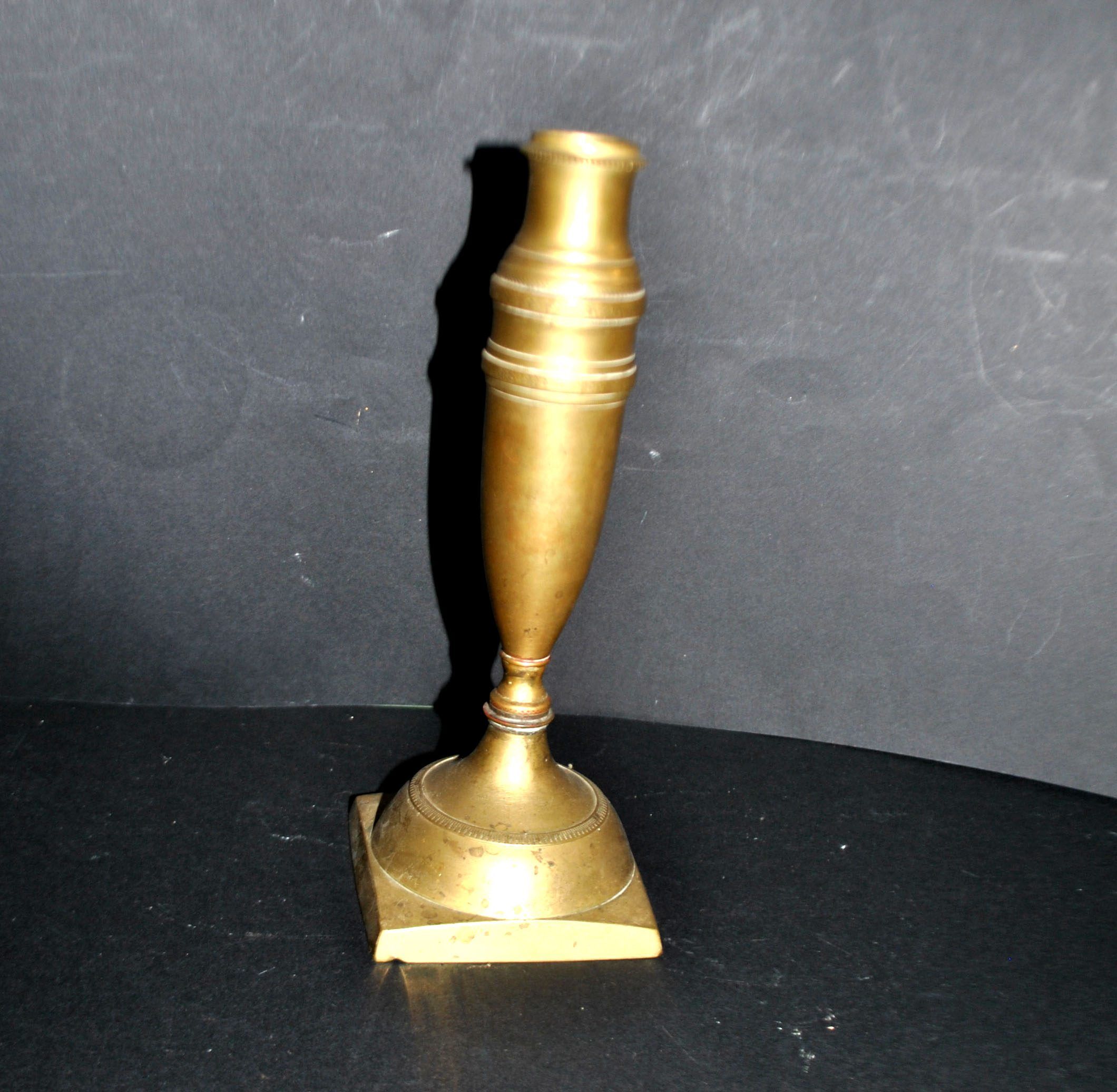 Antique baluster candlestick in bronze with hand-chiseled design.