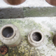 Collection of old sandstone pots with grease and mustard salting
