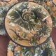 Four antique dessert plates in majolica with vine decoration.