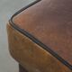 Sturdy vintage sheepskin ottoman in a beautiful large size with black piping