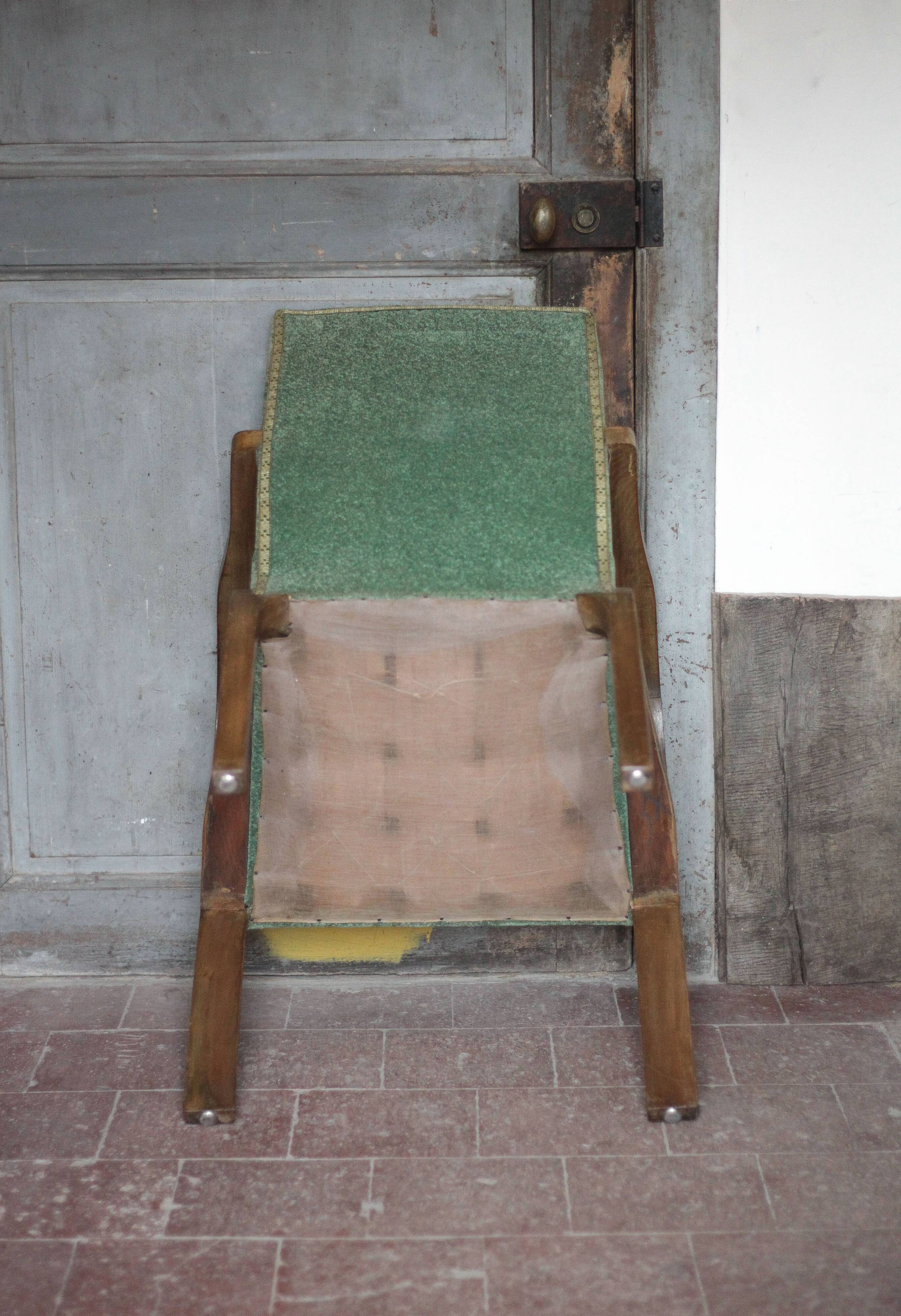 Art Deco armchair in wood and green fabric, living room armchair, interior decor.