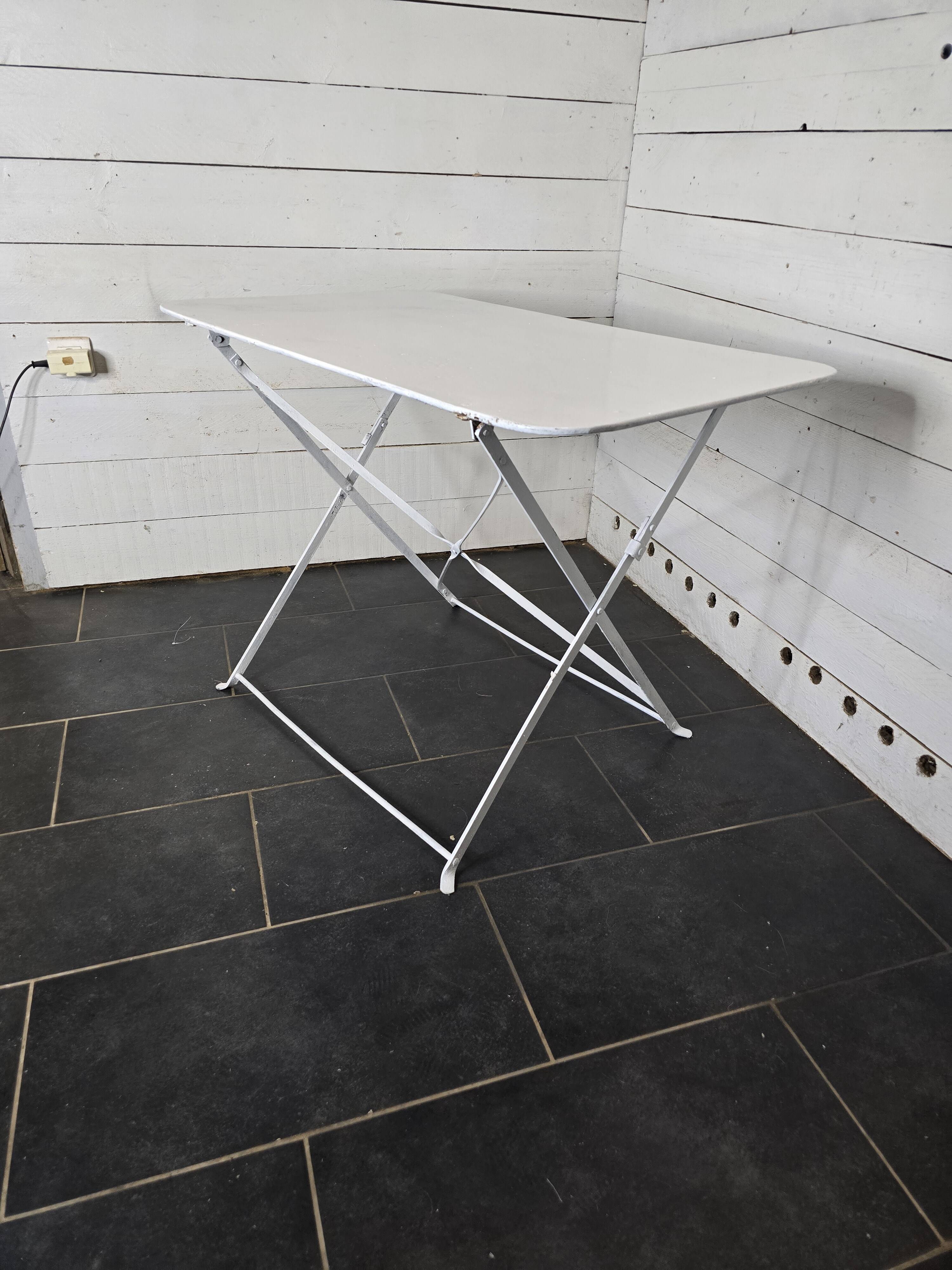 Old folding wrought iron garden table