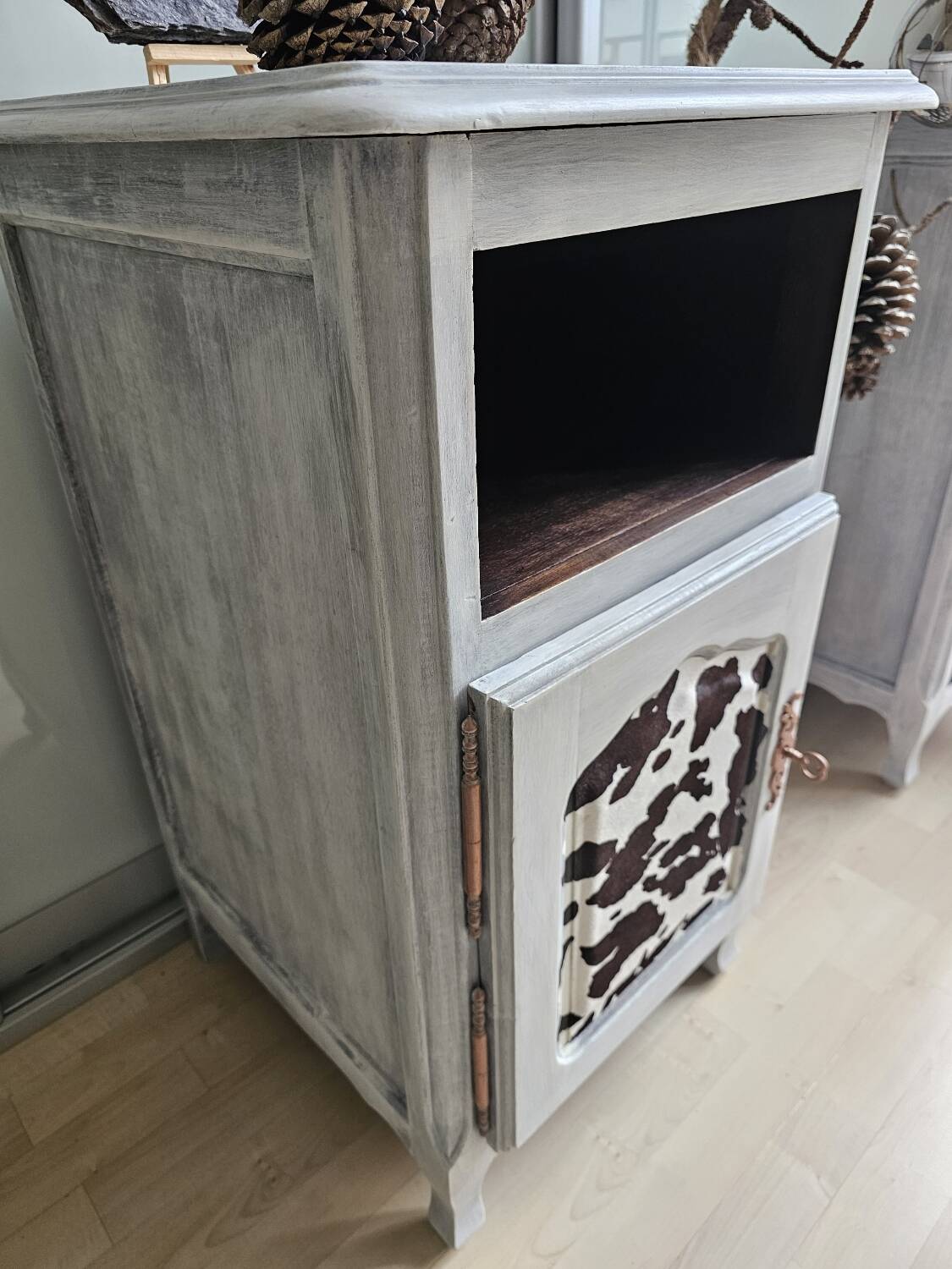Two solid wood bedside tables with calfskin decoration.
