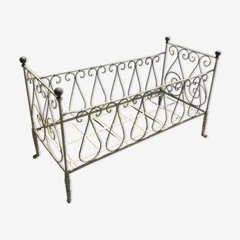 Old baby bed in wrought iron