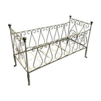 Old baby bed in wrought iron