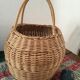 Round basket Wicker braided with two handles.