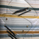 2 small side tables in glass and Bakelite with gold nuts from the 1960s.