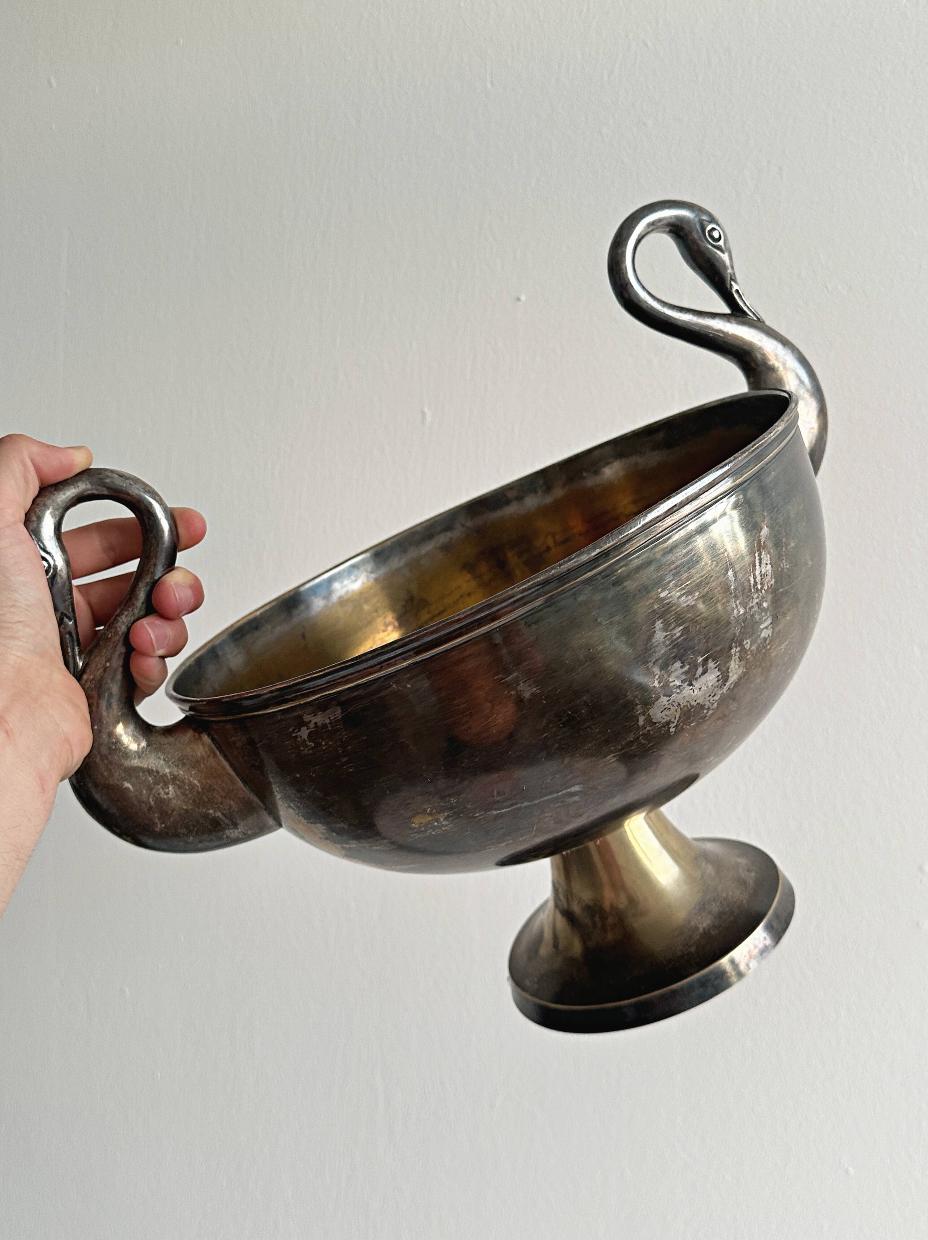 Large champagne bucket with patinated metal swan handles.