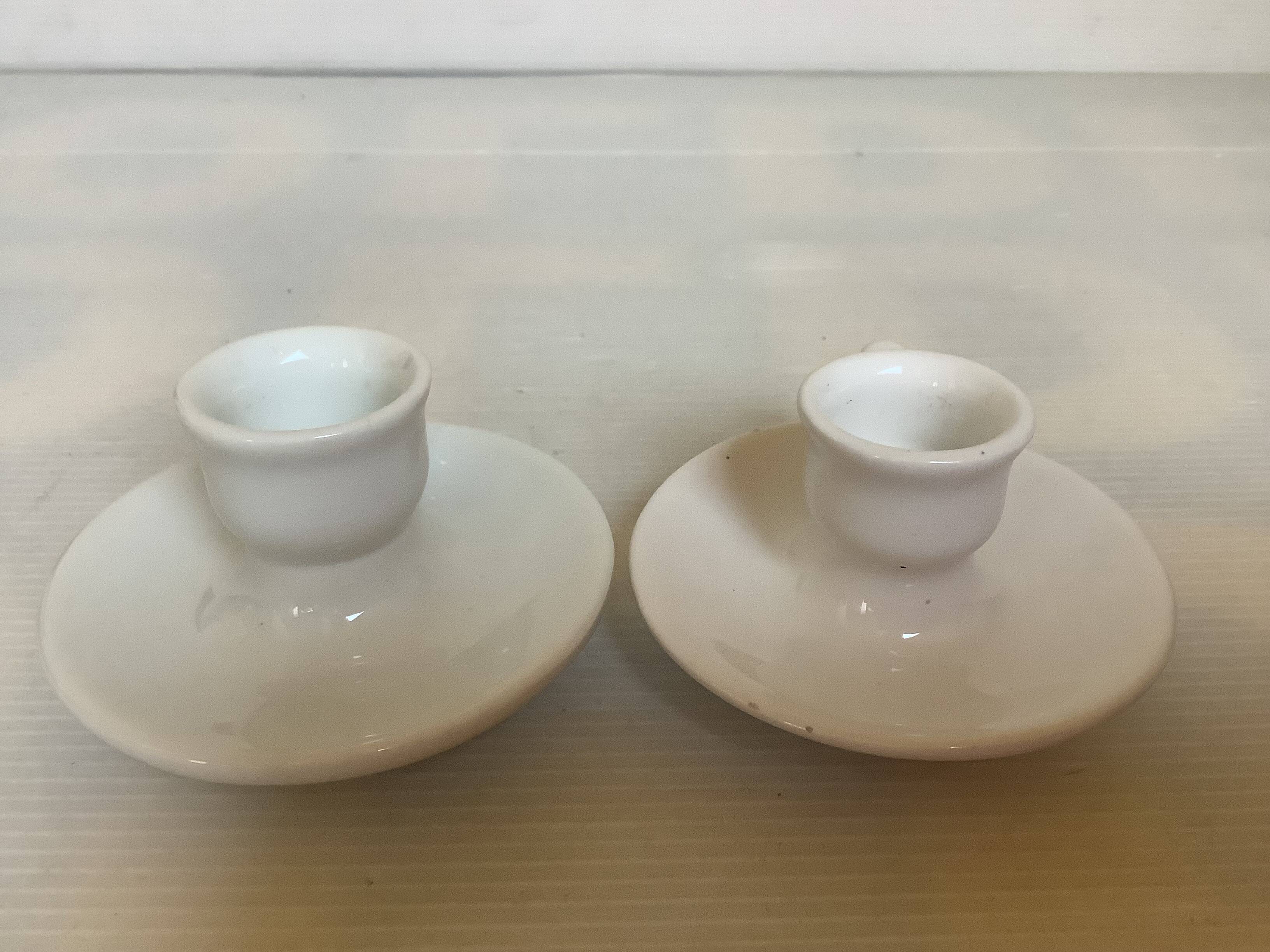 Pair of small white cellar rat candlesticks