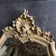 Antique bevelled baroque mirror in patinated wood