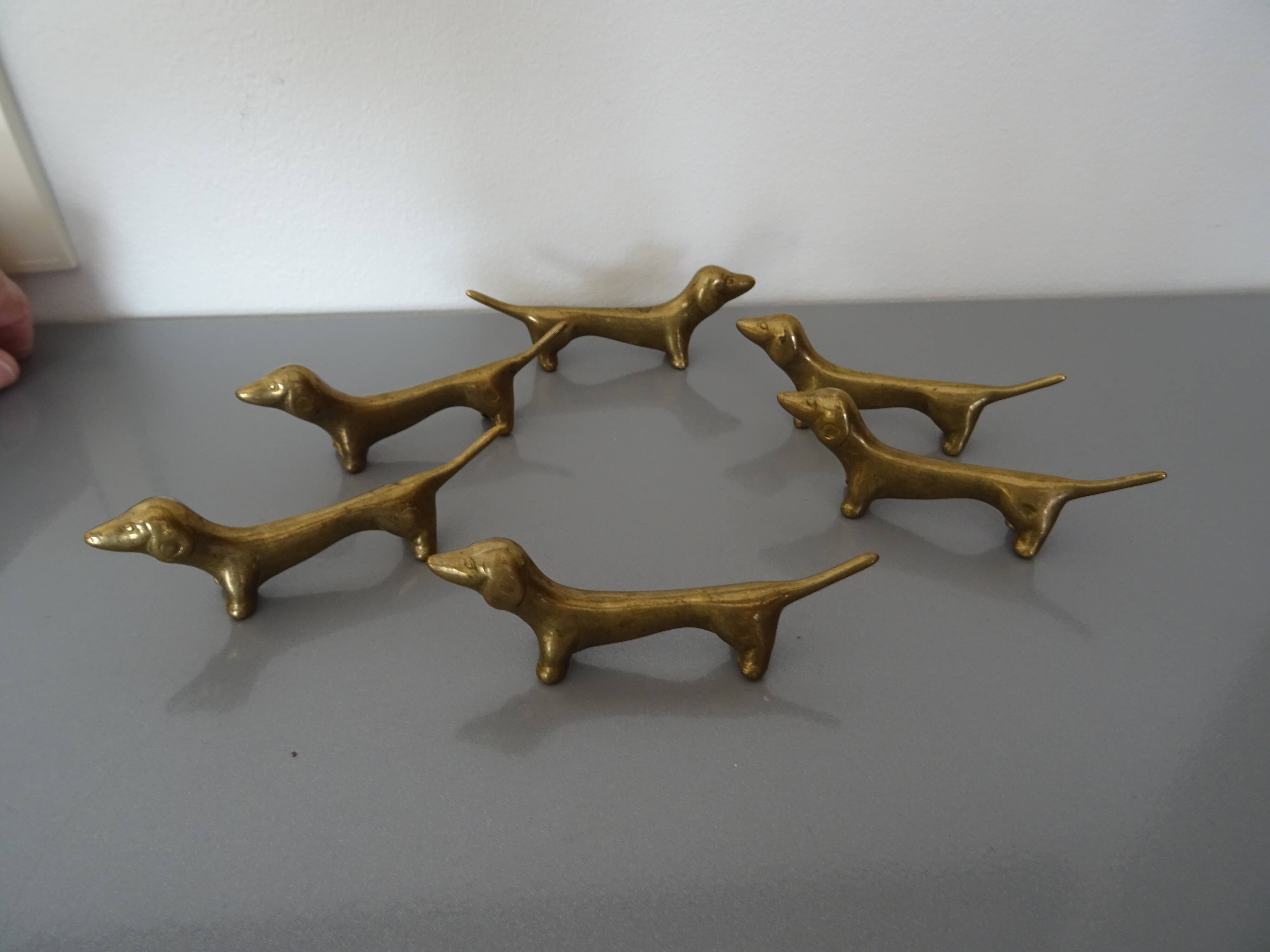 Series of 6 vintage gilded brass dachshund knife holders