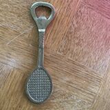 Bottle opener, opens bottle in golden brass shape of racket design and vintage