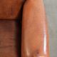 Comfortable vintage sheepskin armchair finished with decorative nails