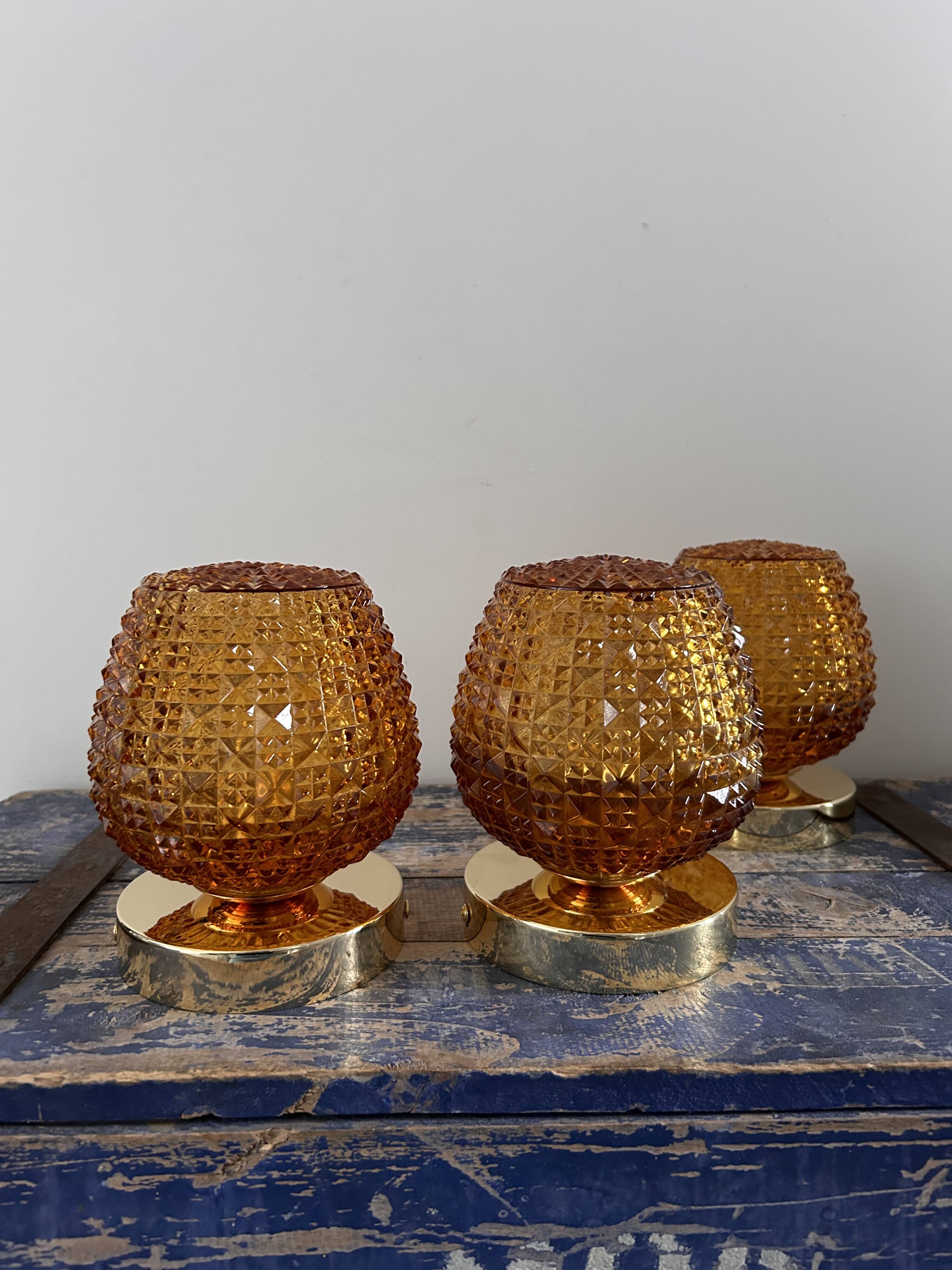 Set of three vintage wall or ceiling lights in amber chiseled glass