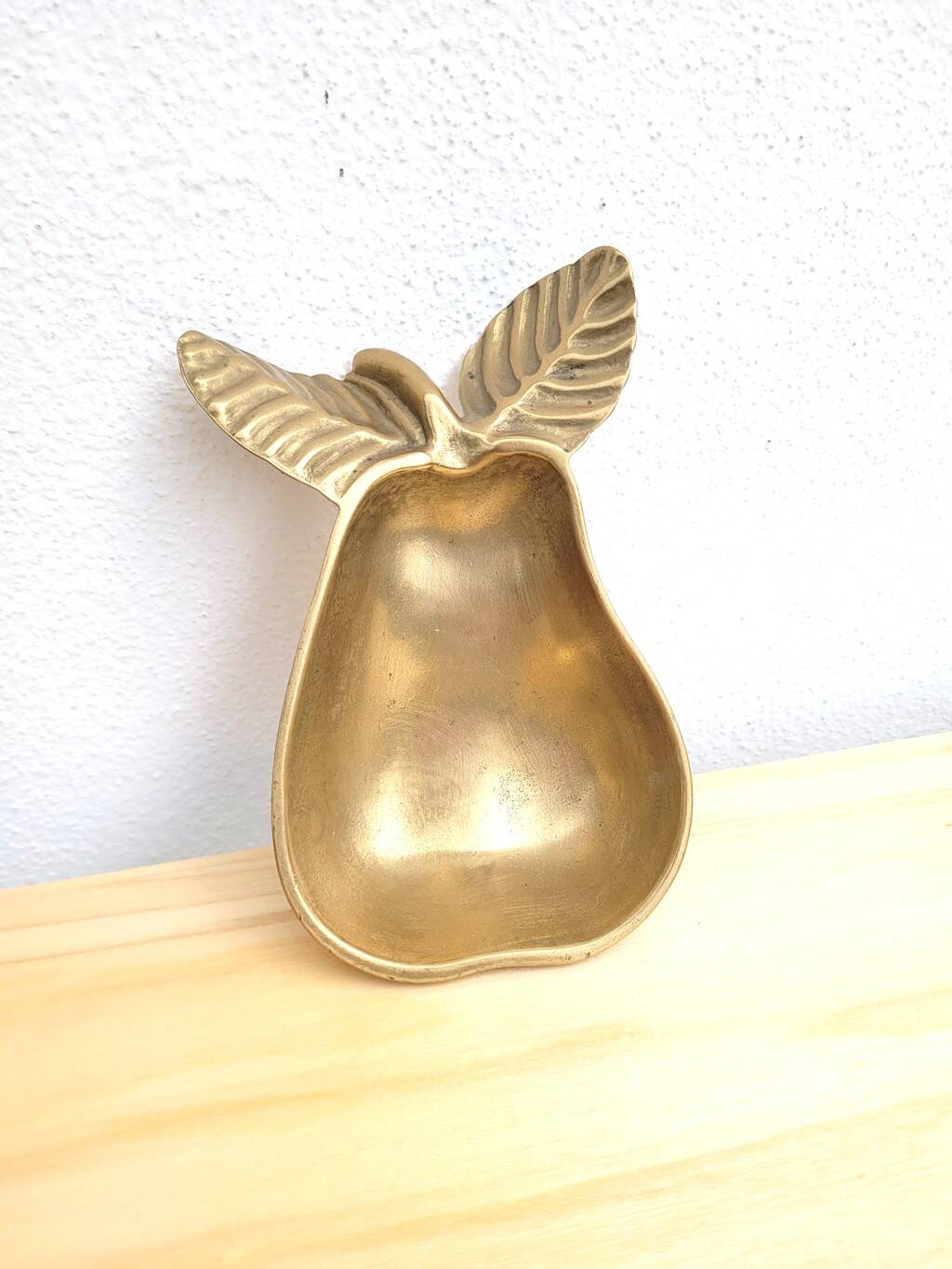 Pear-shaped pocket emptier in gilded brass