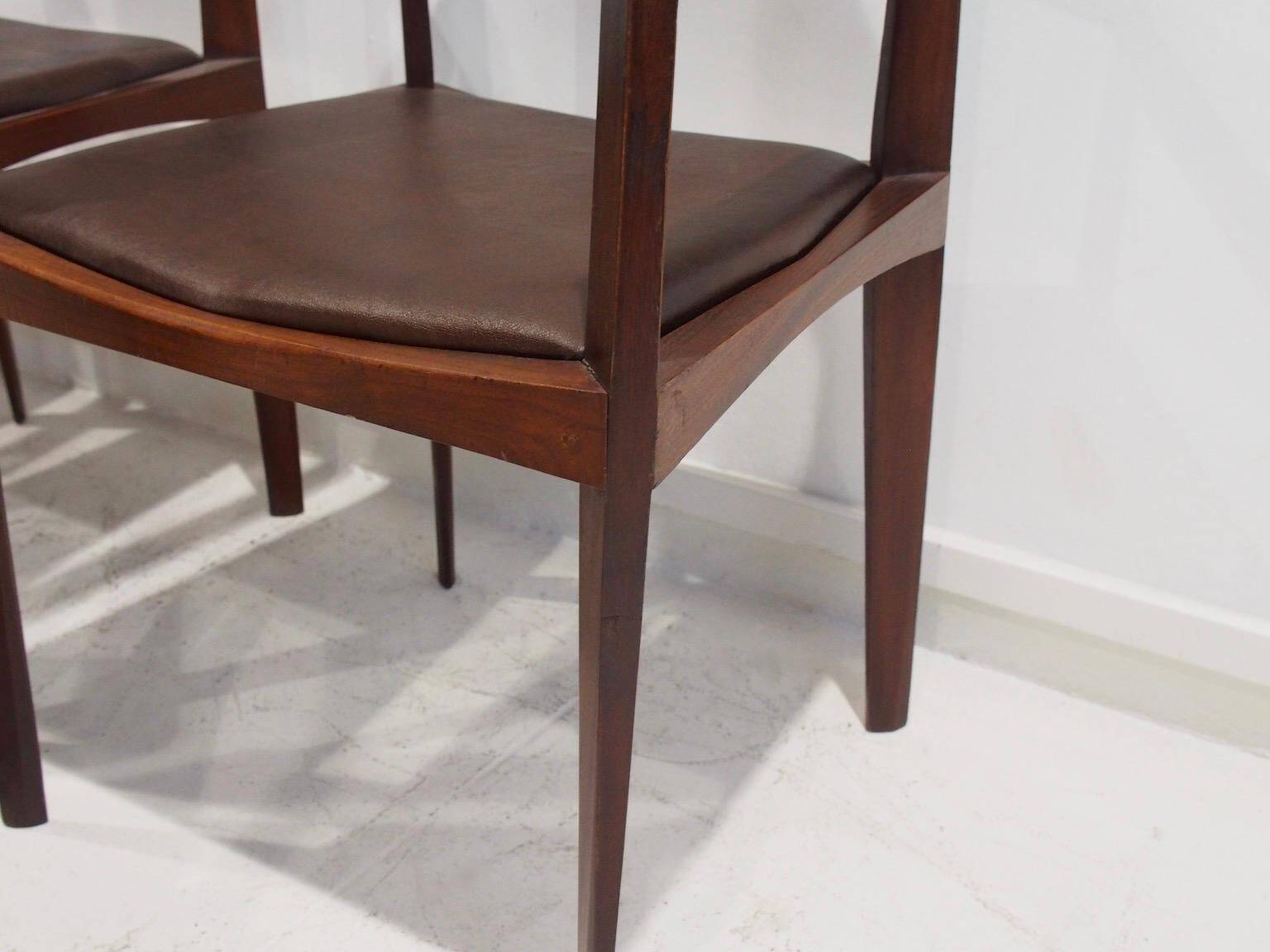 Set of six Italian wooden dining chairs in dark brown faux leather.
