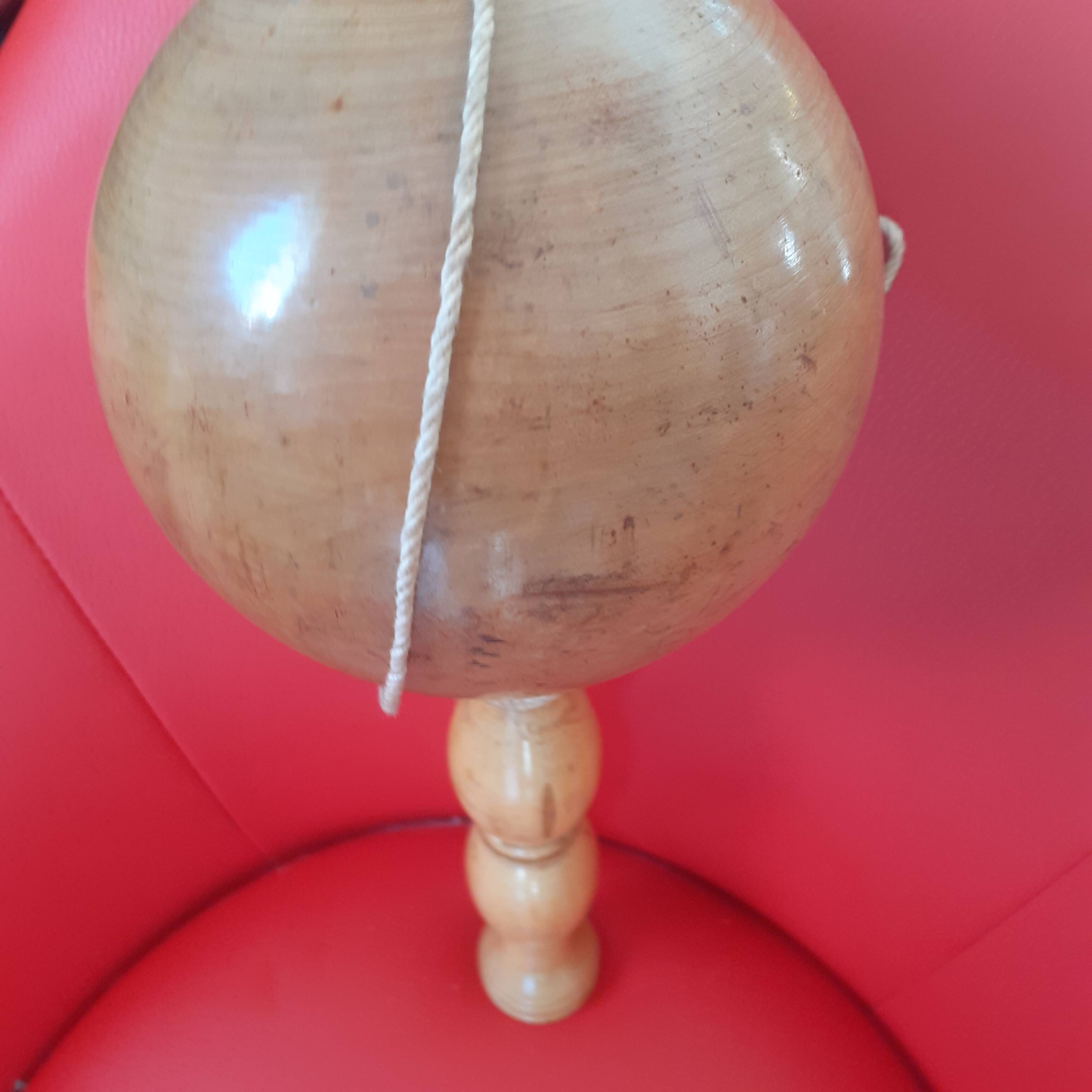 Large cup-and-ball cup in light wood.