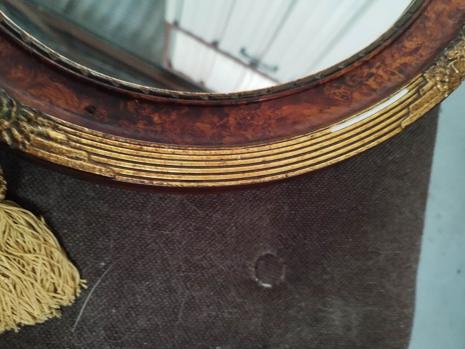 Golden oval art deco mirror